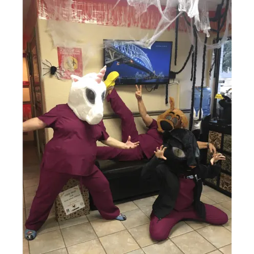 Front Desk Staff Posing with Costume Animal Heads 